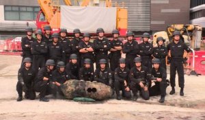 Hong Kong police pose with defused WWII bomb