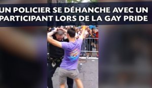 Un policier se déhanche avec un participant lors de la Gay Pride