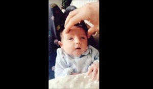 Ce bébé adore les papouilles sur le crâne...