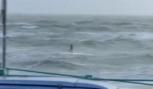 Kitesurfer jumps over pier Lewis_Crathern
