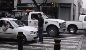 Un homme bloque les voitures qui sont sur le passage piéton