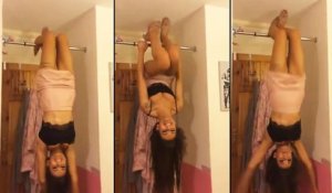 Une fille essaye de faire de la gymnastique dans sa chambre