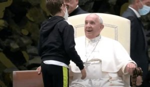 Un jeune enfant handicapé monte aux côtés du pape au début de l'audience